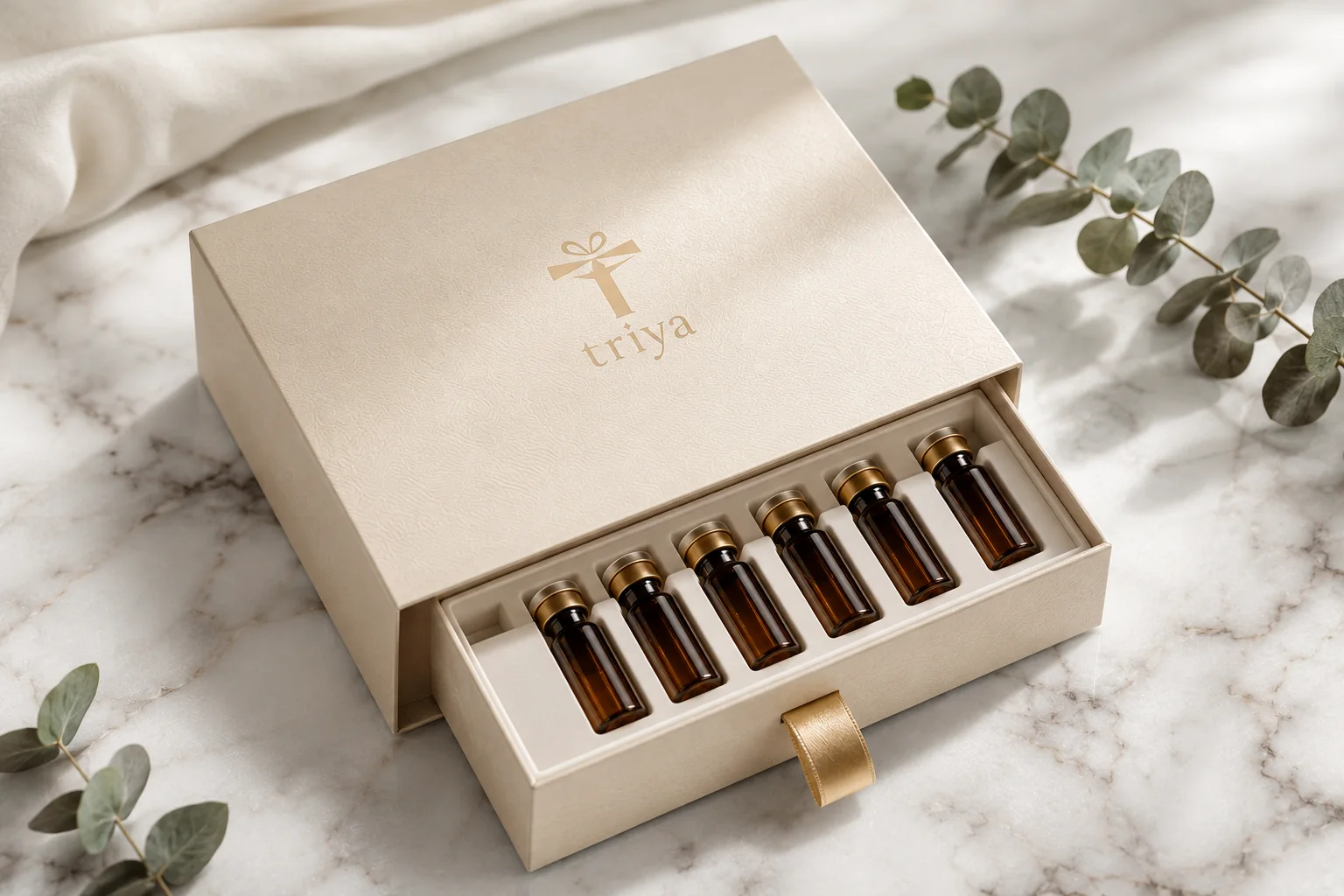 Cream drawer box with a gold Triya logo