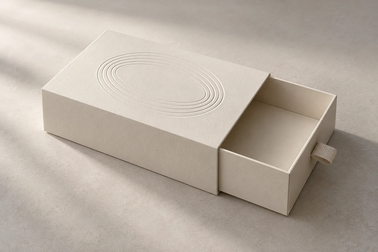 Ivory drawer box with a blind embossed oval pattern on its sleeve