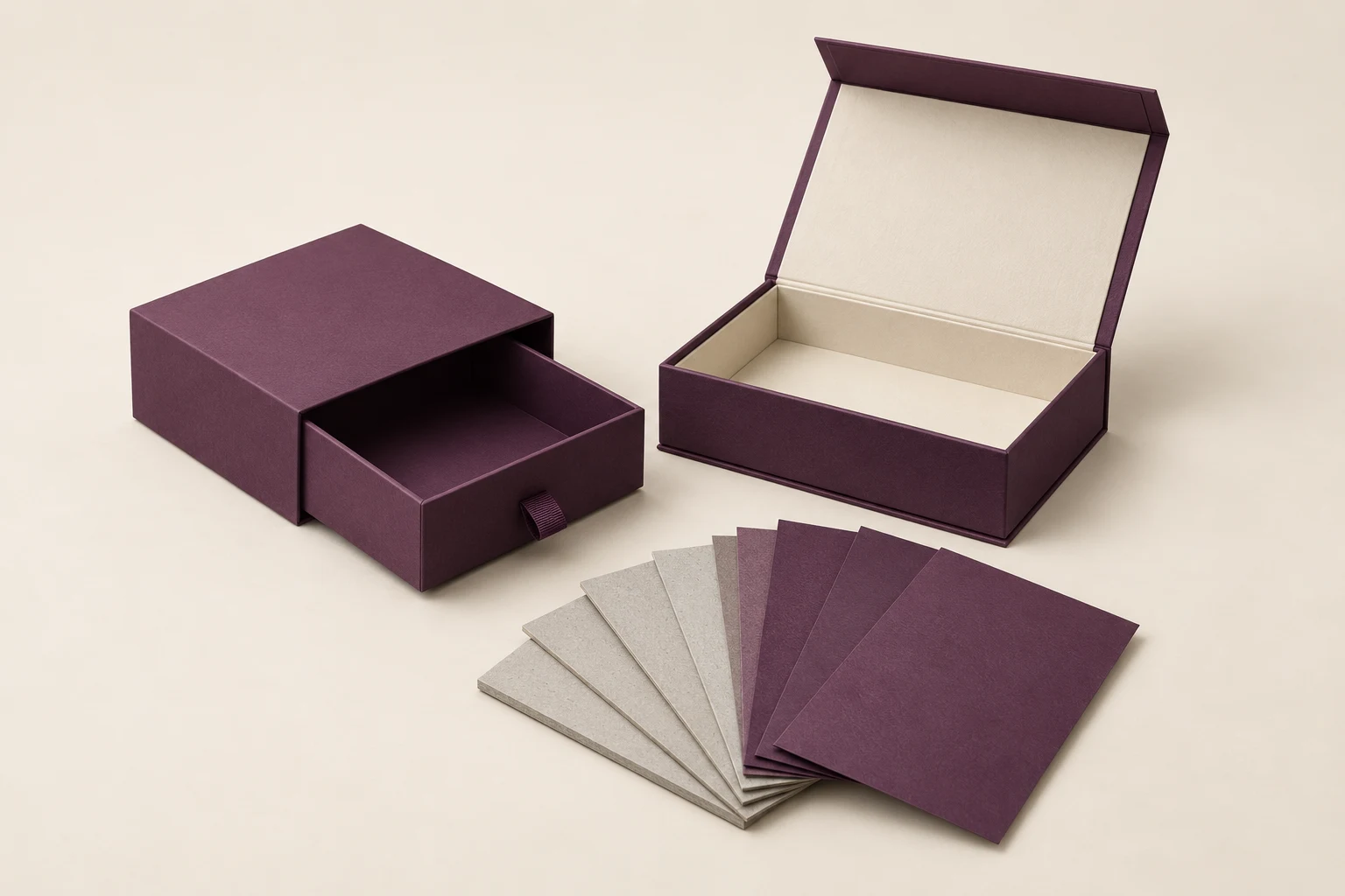 Plum drawer and magnetic gift boxes beside greyboard and purple wrapping-paper swatches